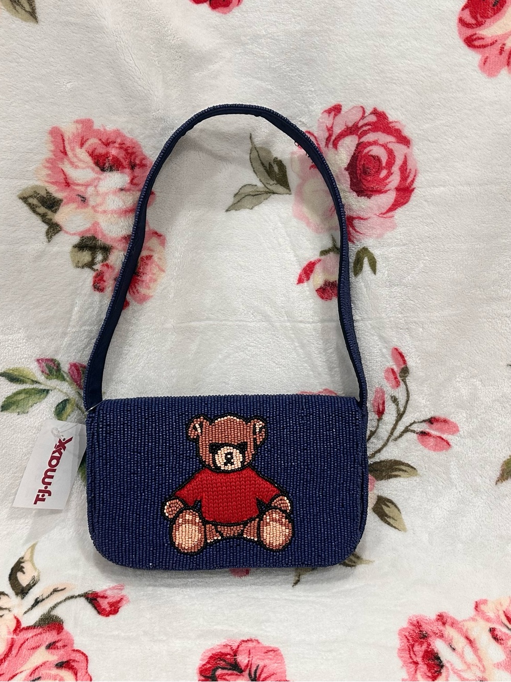 Navy blue beaded shoulder bag featuring a teddy bear with red sweater